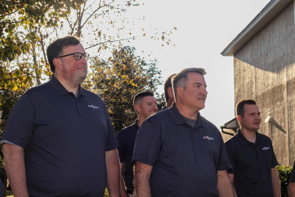 Axiom IT Company workers standing inside a Jacksonville neighborhood