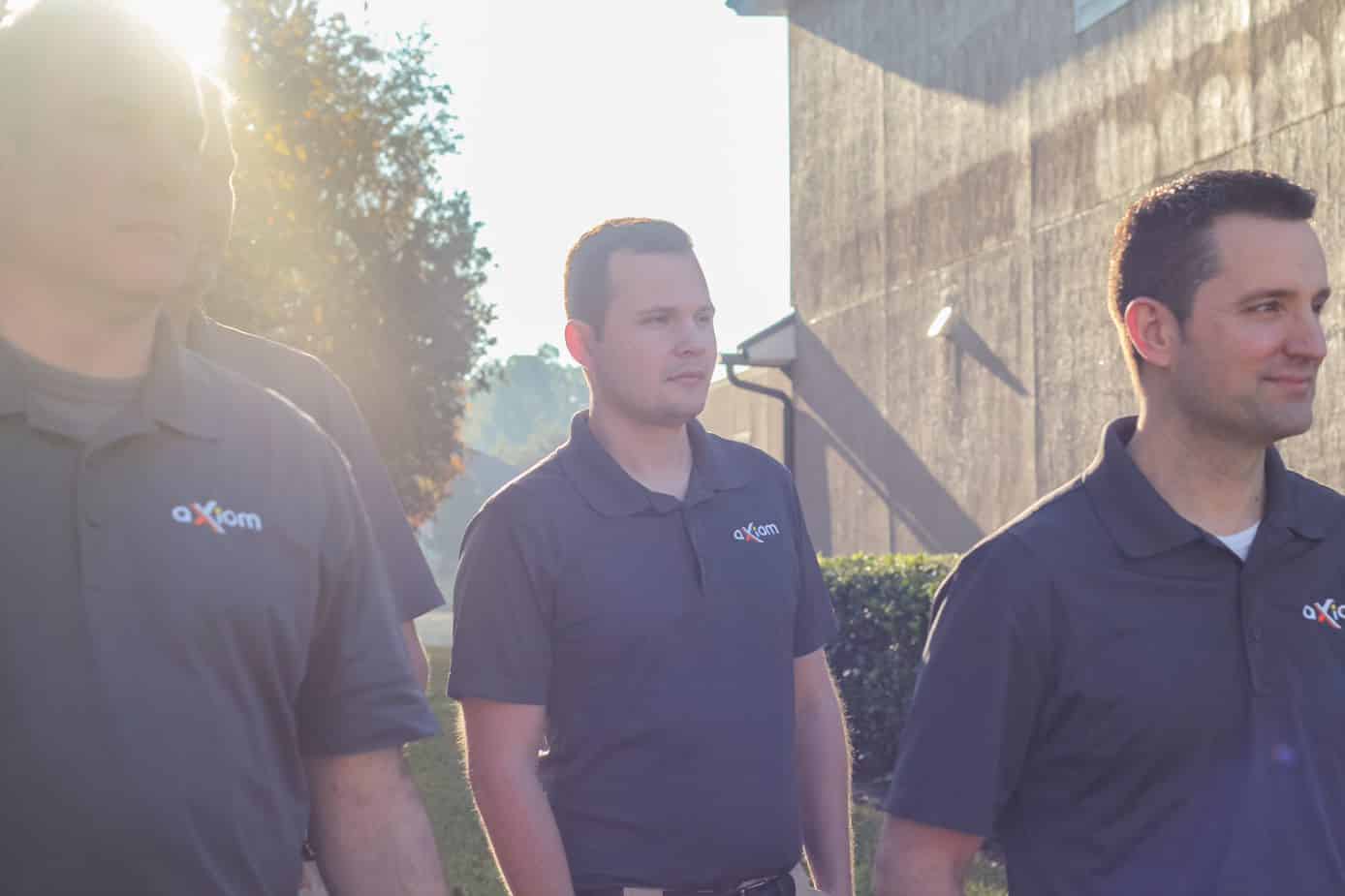 Axiom IT Company workers smiling outside of their clients home