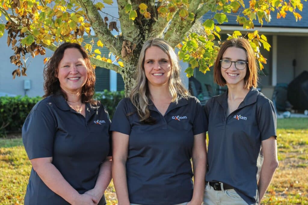 Axiom IT Company workers smiling inside a Jacksonville neighborhood