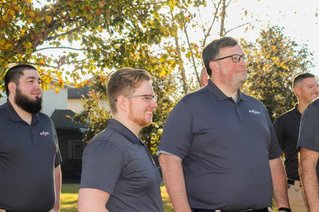 Axiom IT Company workers smiling outside of their clients home