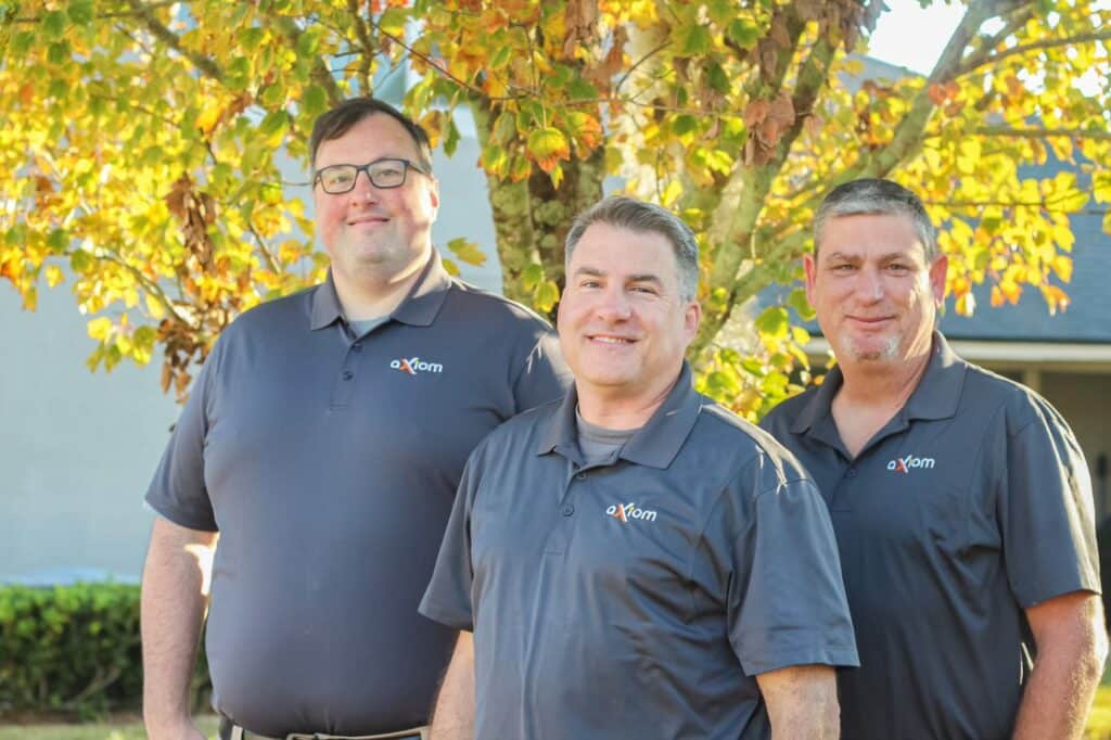 3 men from Axiom IT Company smiling outside of their clients home