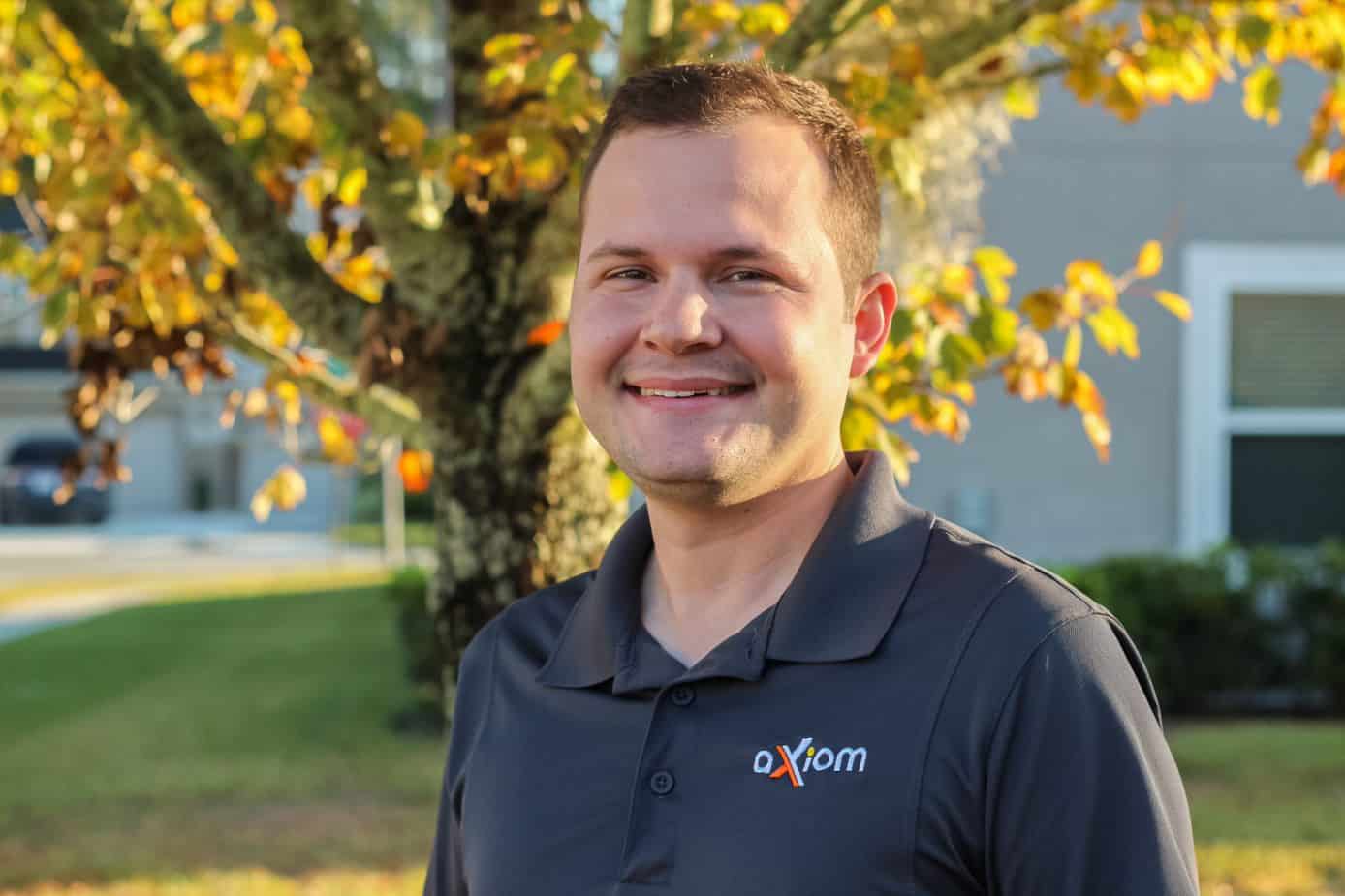 Happy looking man wearing an Axiom IT company shirt