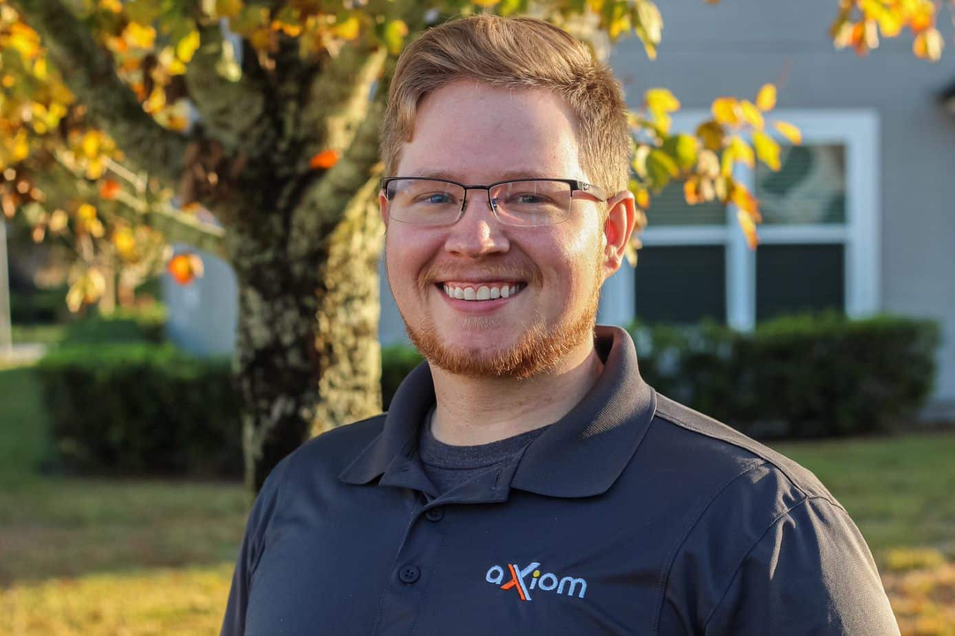 Happy looking man wearing an Axiom IT company shirt