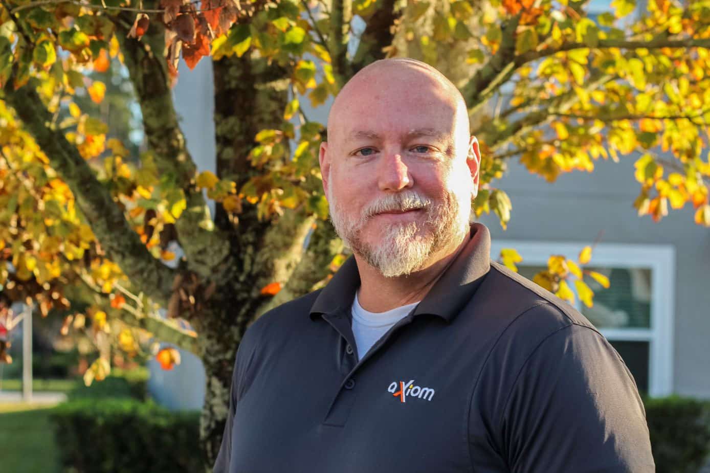 Happy looking man wearing an Axiom IT company shirt