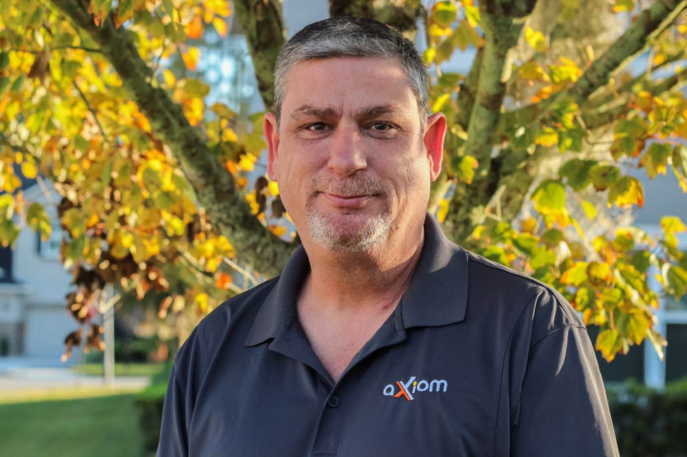 Happy looking man wearing an Axiom IT company shirt