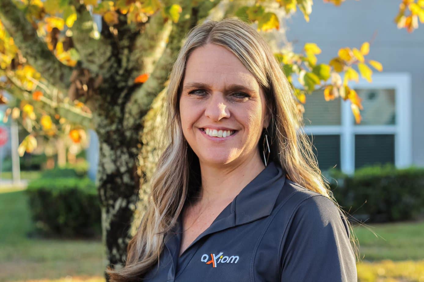 Happy looking woman wearing an Axiom IT company shirt