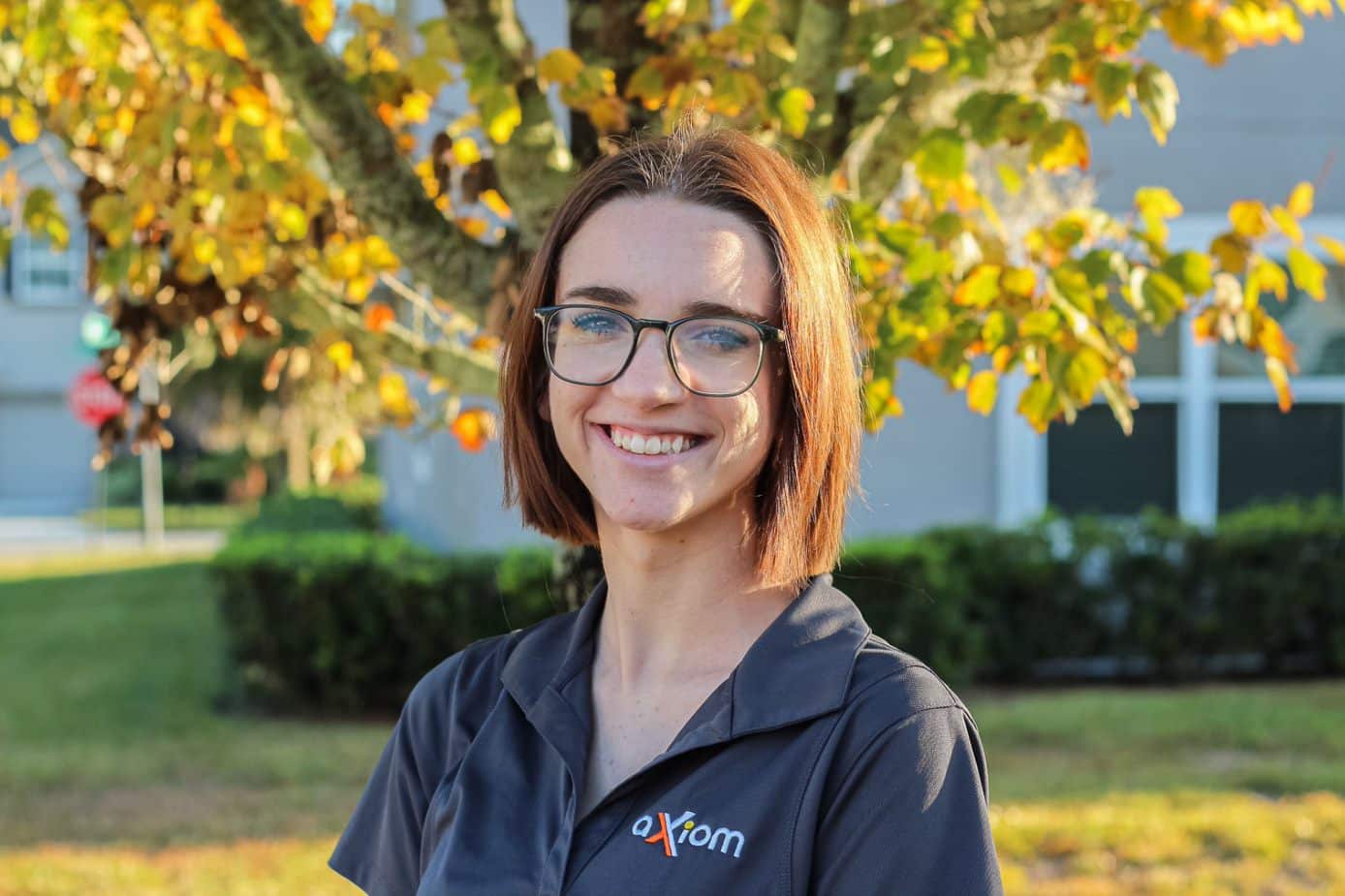 Happy looking woman wearing an Axiom IT company shirt