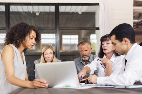 employees looking at laptop and discussing cloud data security